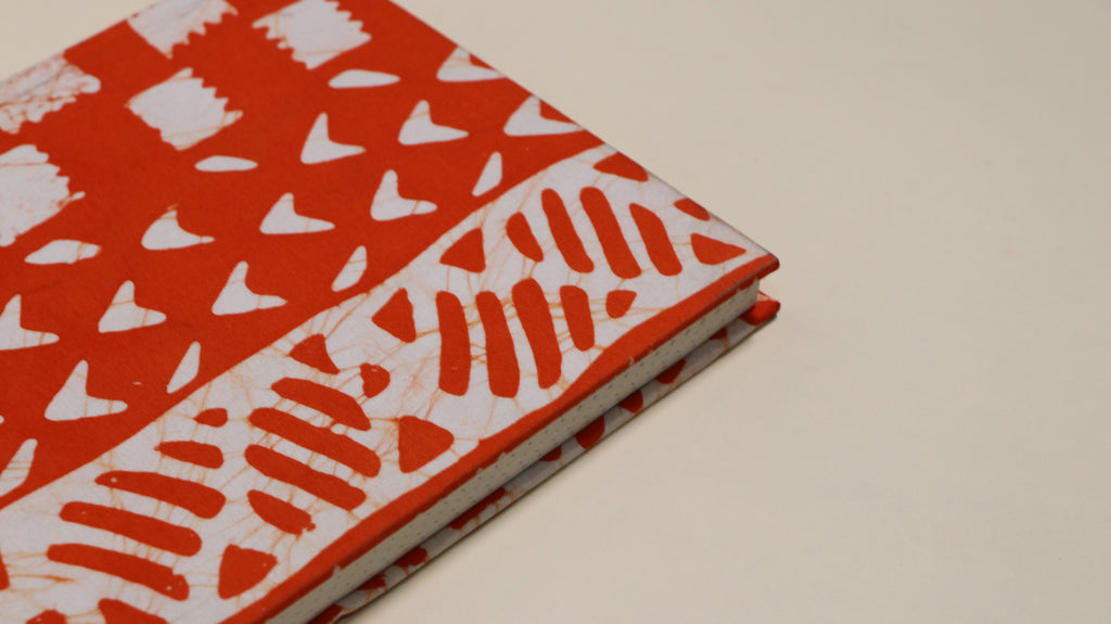 Orange and white printed notebook