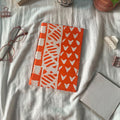 Orange and white printed notebook